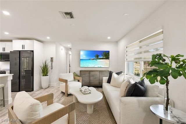 living room with light hardwood / wood-style flooring