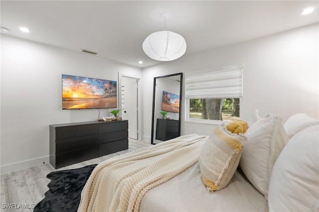 bedroom with light hardwood / wood-style floors