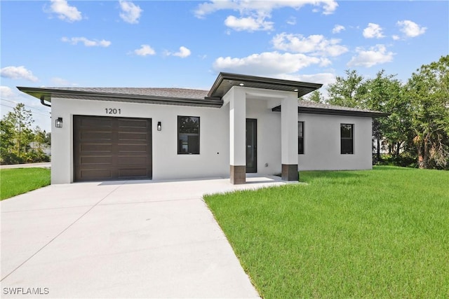 1201 E 7th St, Lehigh Acres, FL 33972 - view of front facade featuring concrete driveway, stucco siding, a front yard, and an attached garage