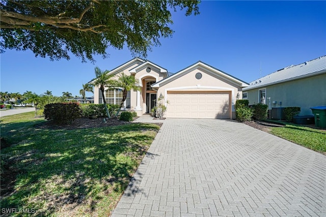 ranch-style home featuring a front lawn and a garage