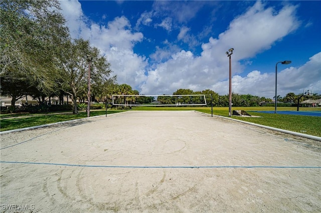 surrounding community with a lawn and volleyball court