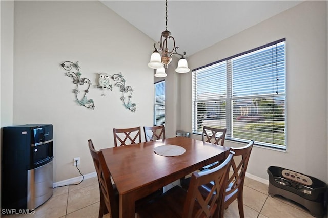 dining area featuring light tile patterned flooring, a wealth of natural light, and vaulted ceiling