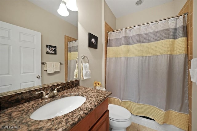 bathroom featuring a shower with shower curtain, vanity, toilet, and tile patterned flooring