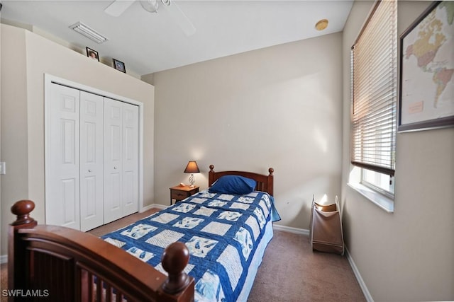 carpeted bedroom with ceiling fan and a closet