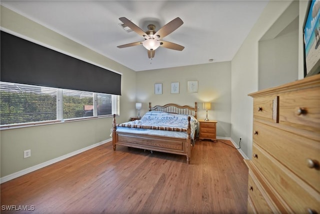 bedroom with ceiling fan and light hardwood / wood-style flooring