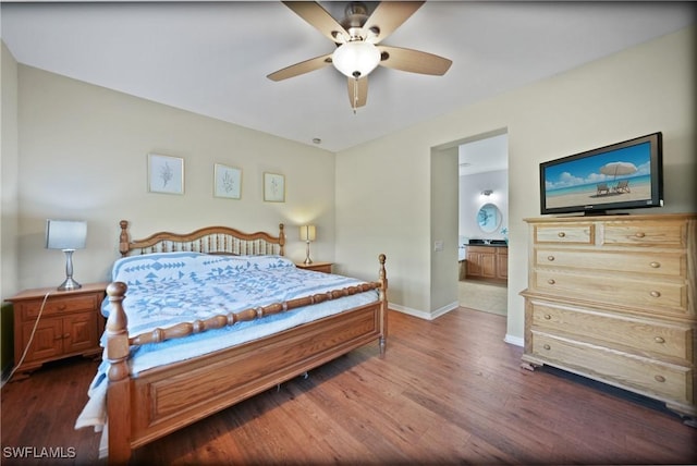 bedroom featuring ceiling fan, dark hardwood / wood-style floors, and connected bathroom