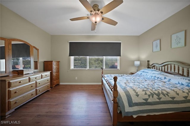 bedroom with dark hardwood / wood-style flooring and ceiling fan