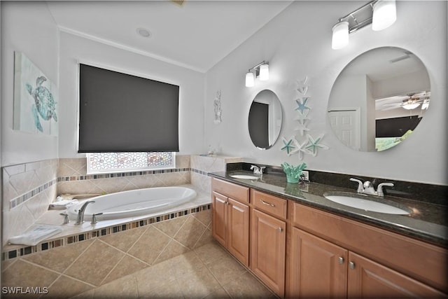 bathroom with vanity, tile patterned floors, ceiling fan, and tiled tub