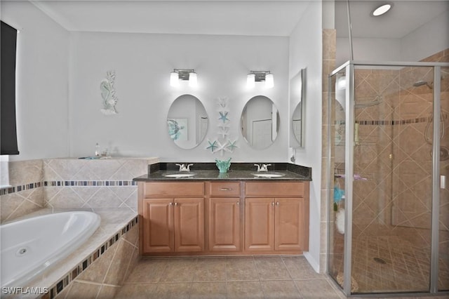 bathroom with tile patterned floors, vanity, and plus walk in shower