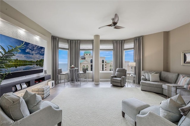 living room with hardwood / wood-style flooring, ceiling fan, and plenty of natural light