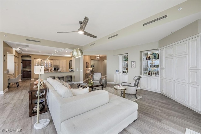 living room featuring ceiling fan and light wood-type flooring