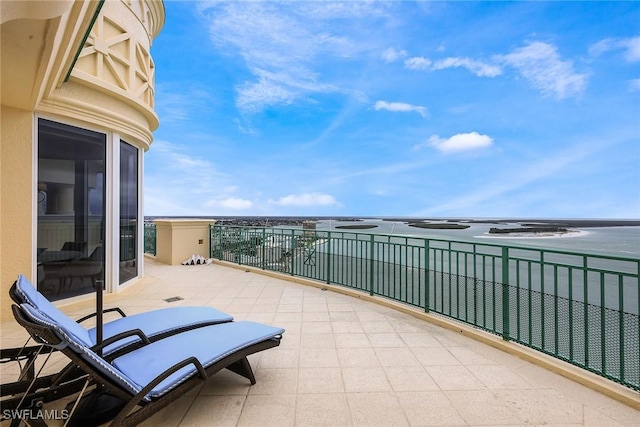 balcony featuring a water view and a patio