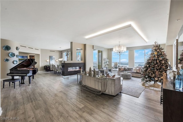 living room with hardwood / wood-style floors and an inviting chandelier