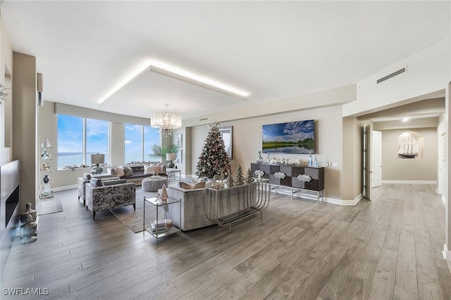 living room featuring hardwood / wood-style floors and an inviting chandelier