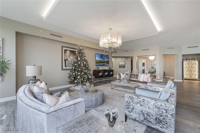 living room featuring hardwood / wood-style flooring and an inviting chandelier