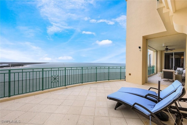 view of patio with a balcony and a water view