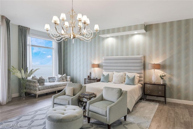 bedroom with hardwood / wood-style floors and an inviting chandelier