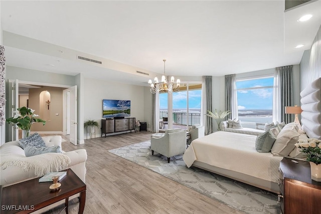 bedroom featuring a chandelier and light hardwood / wood-style floors