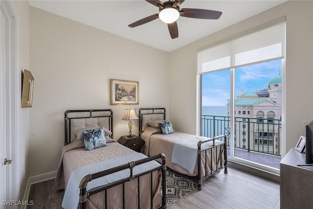 bedroom with ceiling fan, access to exterior, and light hardwood / wood-style flooring