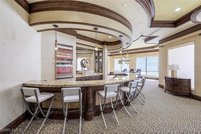 bar with carpet flooring, ornamental molding, and hanging light fixtures