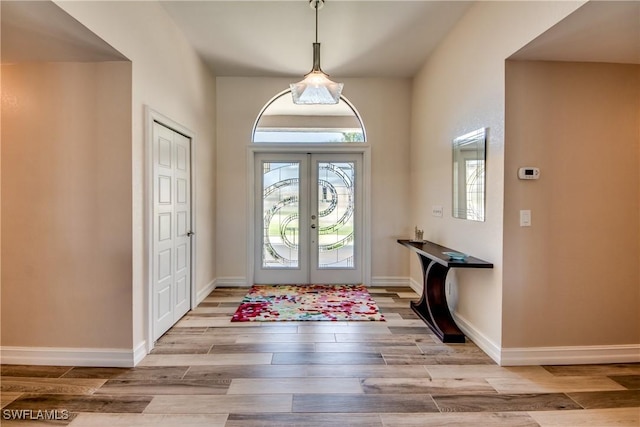 entrance foyer with french doors and light wood-type flooring