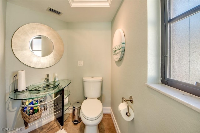 bathroom featuring sink, tile patterned flooring, and toilet