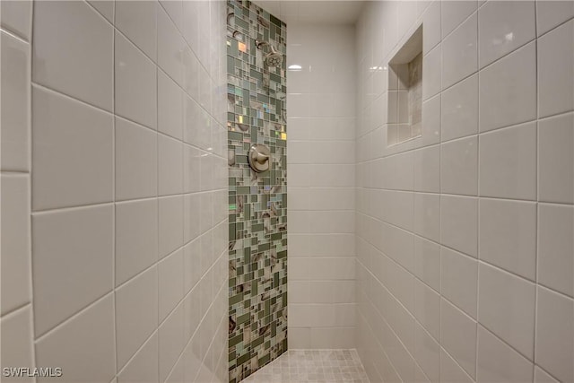 bathroom with tiled shower