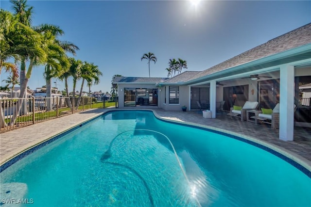 view of swimming pool featuring a patio area and ceiling fan