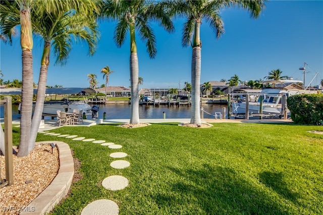 view of yard featuring a water view and a boat dock