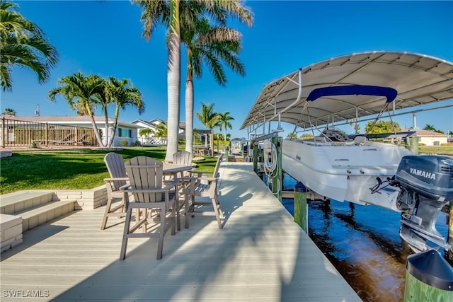 view of dock with a lawn