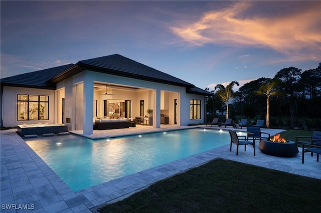 pool with a patio area, an outdoor living space with a fire pit, and ceiling fan