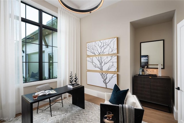 office area featuring baseboards and wood finished floors