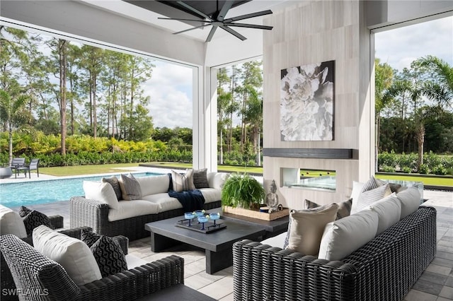 sunroom / solarium with a ceiling fan and a wealth of natural light