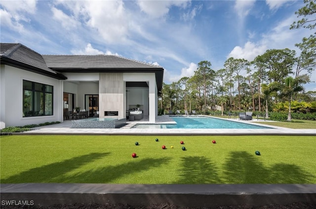 pool with a patio area and a yard