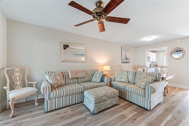 living room featuring a textured ceiling and light hardwood / wood-style flooring