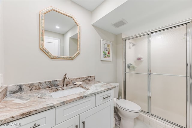 bathroom with toilet, tile patterned flooring, walk in shower, and vanity