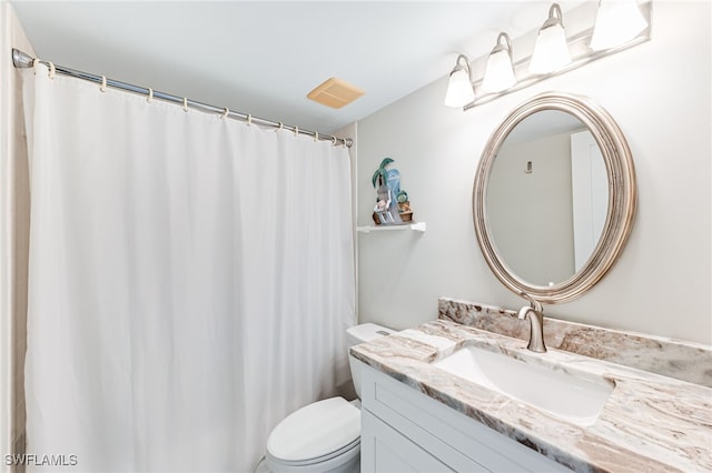 bathroom featuring toilet and vanity