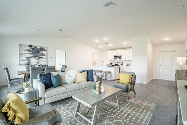 living room featuring lofted ceiling and dark wood-type flooring