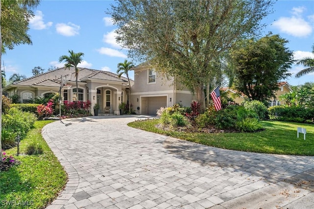 view of front of house with a garage and a front lawn