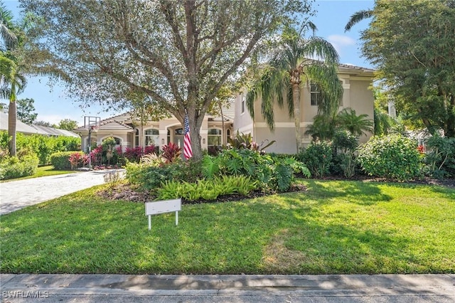 mediterranean / spanish-style house featuring a front lawn