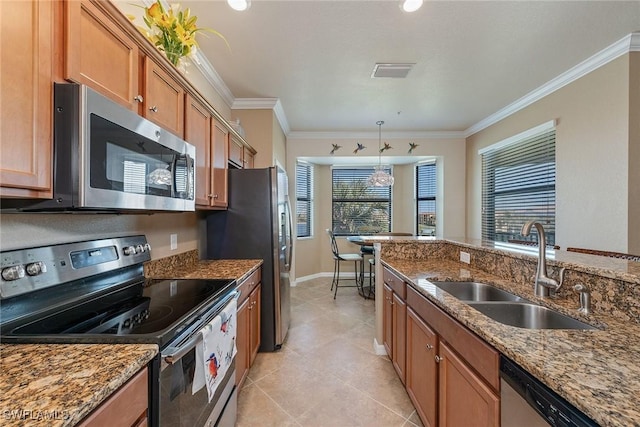 kitchen with pendant lighting, sink, crown molding, stone countertops, and stainless steel appliances