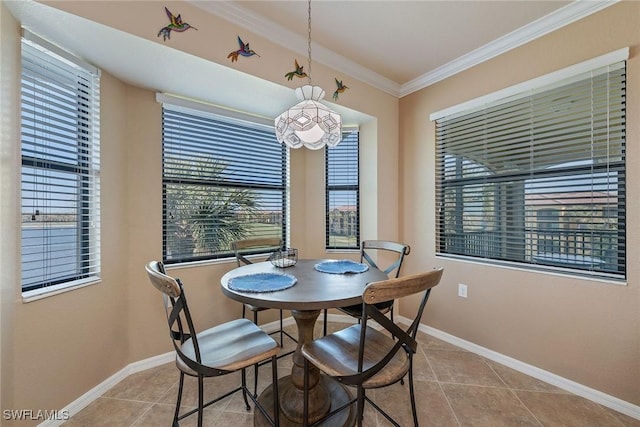 dining area with light tile patterned flooring and ornamental molding