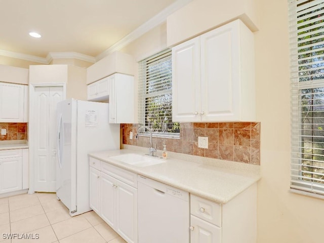 kitchen featuring sink, white cabinets, white appliances, ornamental molding, and light tile patterned floors