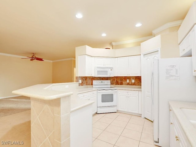 kitchen featuring white cabinets, white appliances, light tile patterned floors, kitchen peninsula, and crown molding