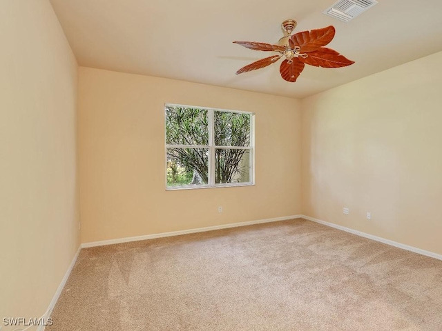 empty room featuring ceiling fan and light colored carpet