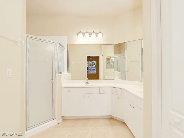 bathroom featuring tile patterned floors, walk in shower, and vanity