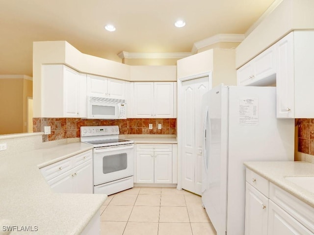 kitchen featuring white appliances, white cabinetry, ornamental molding, and light tile patterned floors