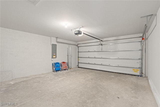 garage with a garage door opener and electric panel