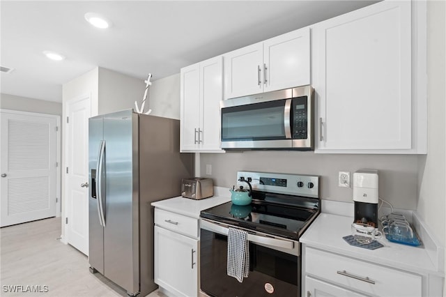 kitchen with white cabinetry and appliances with stainless steel finishes