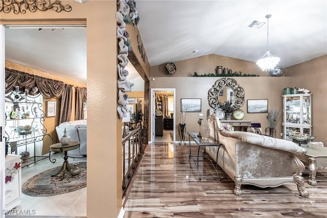 living room with a notable chandelier and lofted ceiling